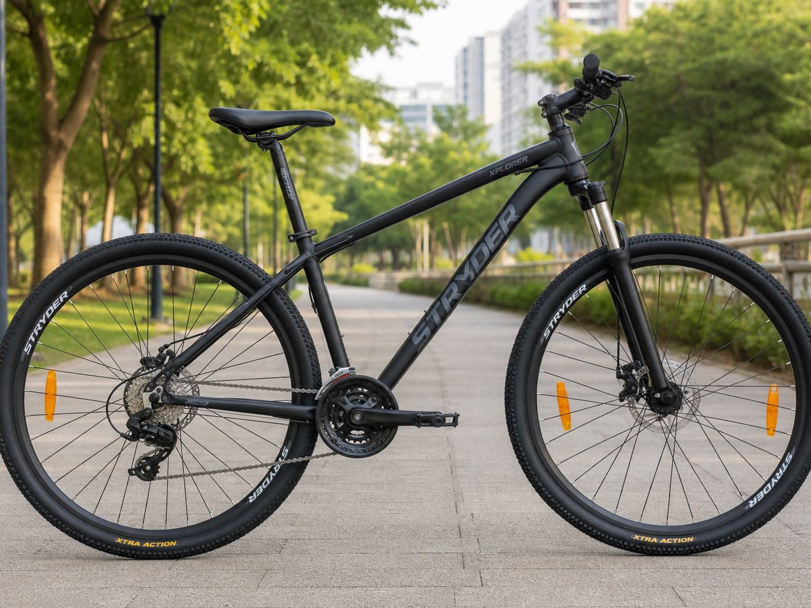 Black 21-speed gear cycle standing on a paved park path outdoors