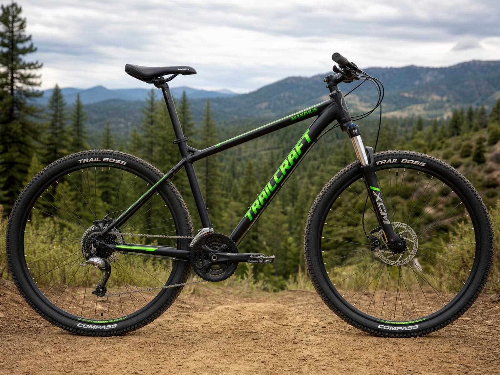 Mountain bike standing on a dirt trail with forest hills behind